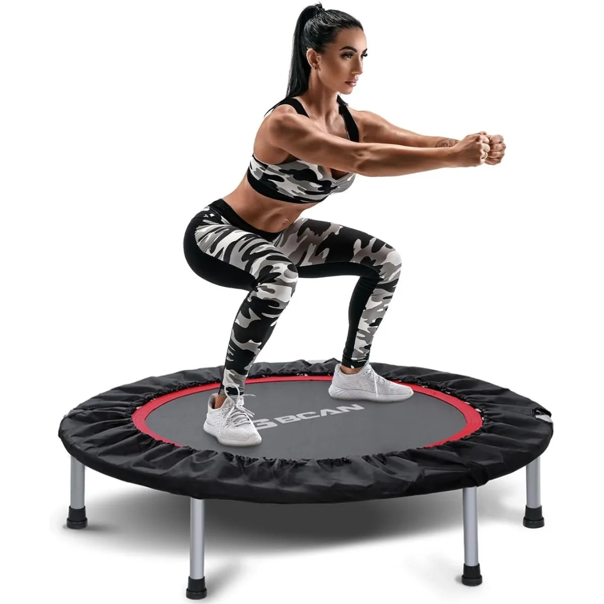 Woman exercising on a reebok trampoline against a white background