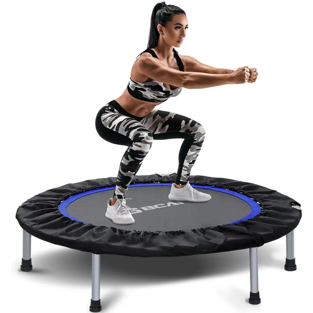 Woman exercising on a black and blue Rebo trampoline against a white background