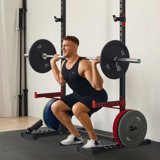 Man performing squats with a barbell in a gym setting