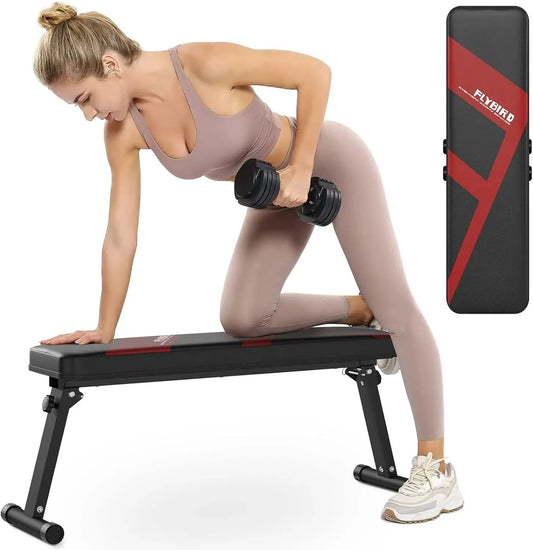 Woman exercising with a weight bench and dumbbells, with a mat in the corner.