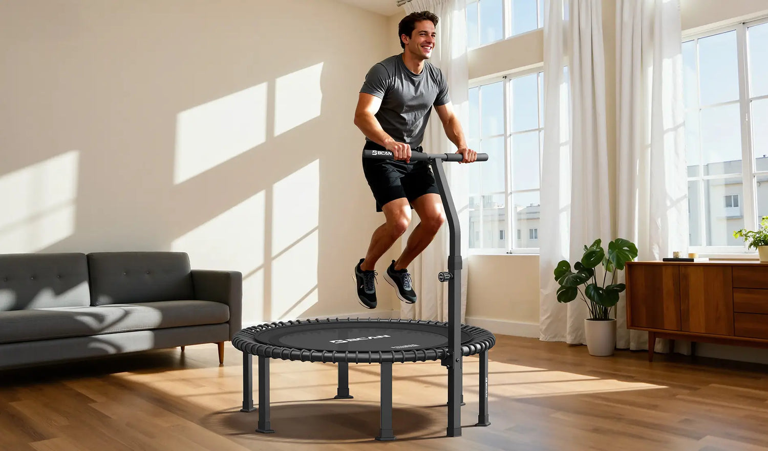 A man is bouncing on a mini-trampoline in the living room.