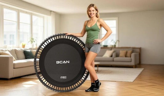 A woman with a well-proportioned figure is showing off her physique and the trampoline she is using.