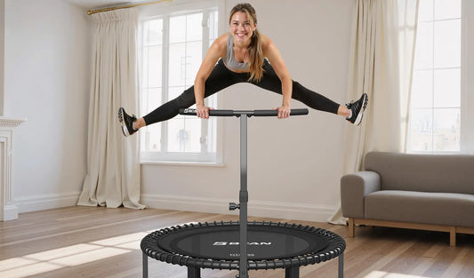 A woman exercising on a fitness trampoline while holding onto a support