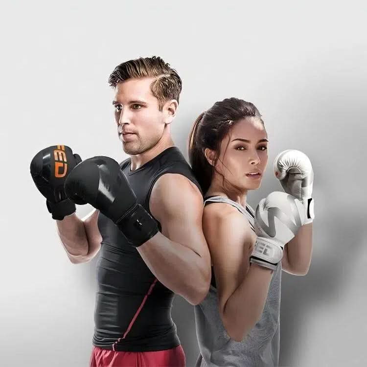 A man and a woman, both wearing FED Fitness boxing gloves, stand back to back