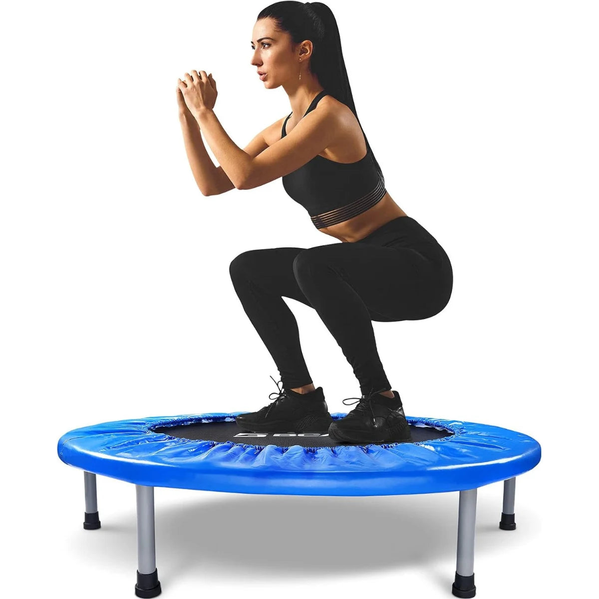 Woman exercising on a blue rebounder against a white background
