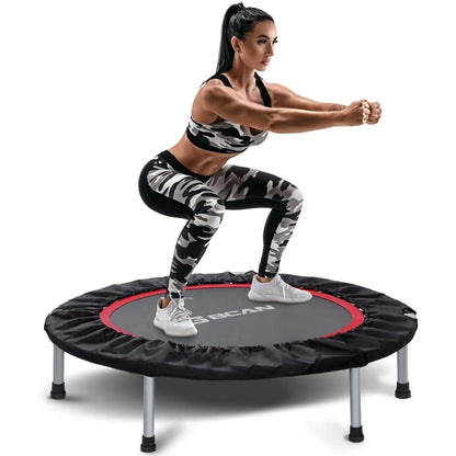 Woman exercising on a reebok trampoline against a white background
