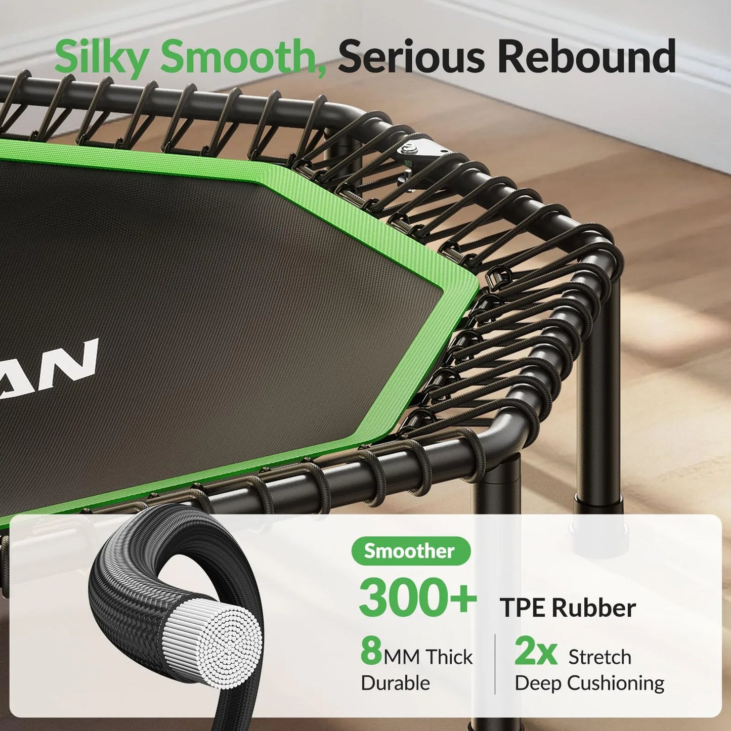 Green and black trampoline with TPE rubber details on a wooden floor.
