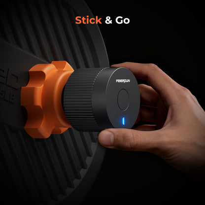 Hand holding a black and orange device with 'Stick & Go' branding on a dark background