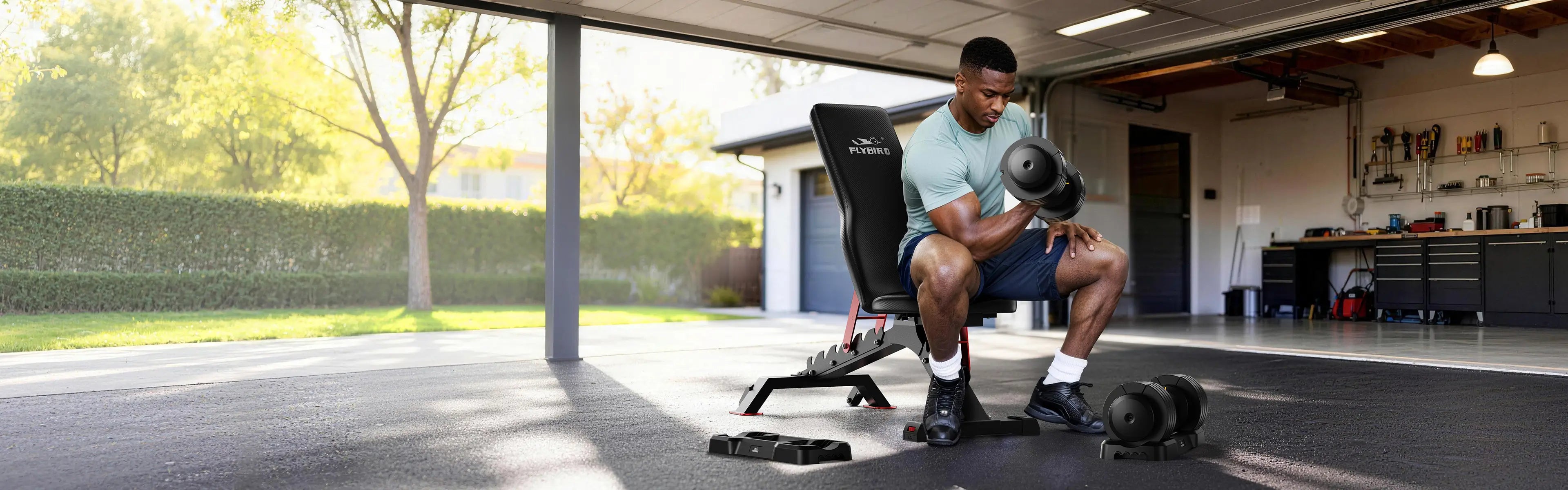 A man is sitting on a dumbbell bench, performing dumbbell curls