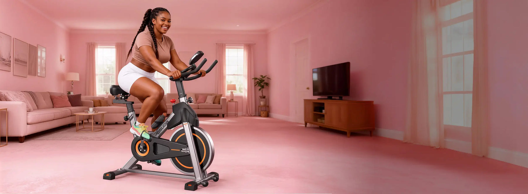 Woman exercising on a stationary bike in a pink room with a TV and couch.