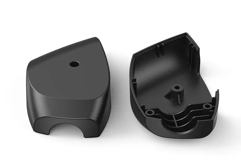 Two black plastic components on a white background