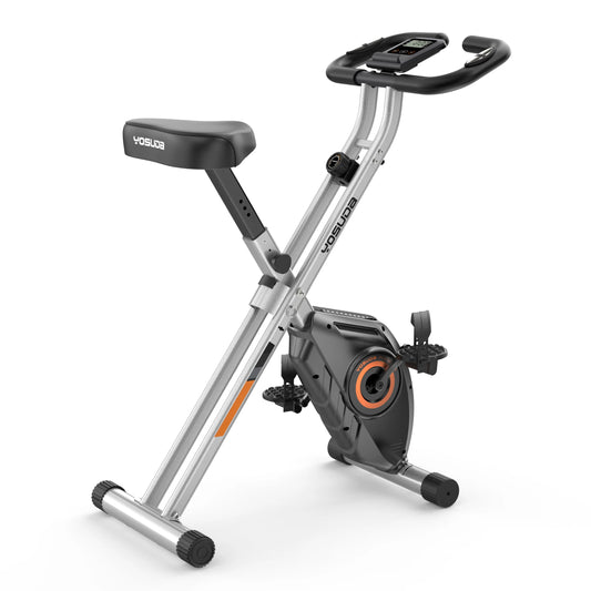 Foldable exercise bike with digital display on a white background
