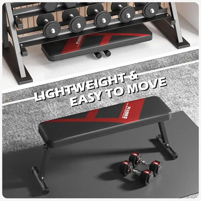 Foldable weight bench with red accents on a gray floor, surrounded by dumbbells.